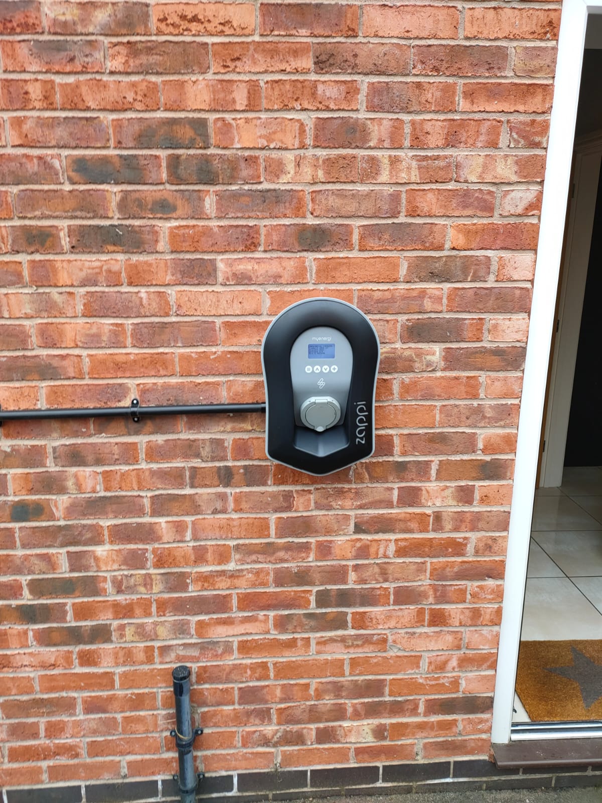 A myenergi Zappi EV charger, it is installed on the wall and looks great.,