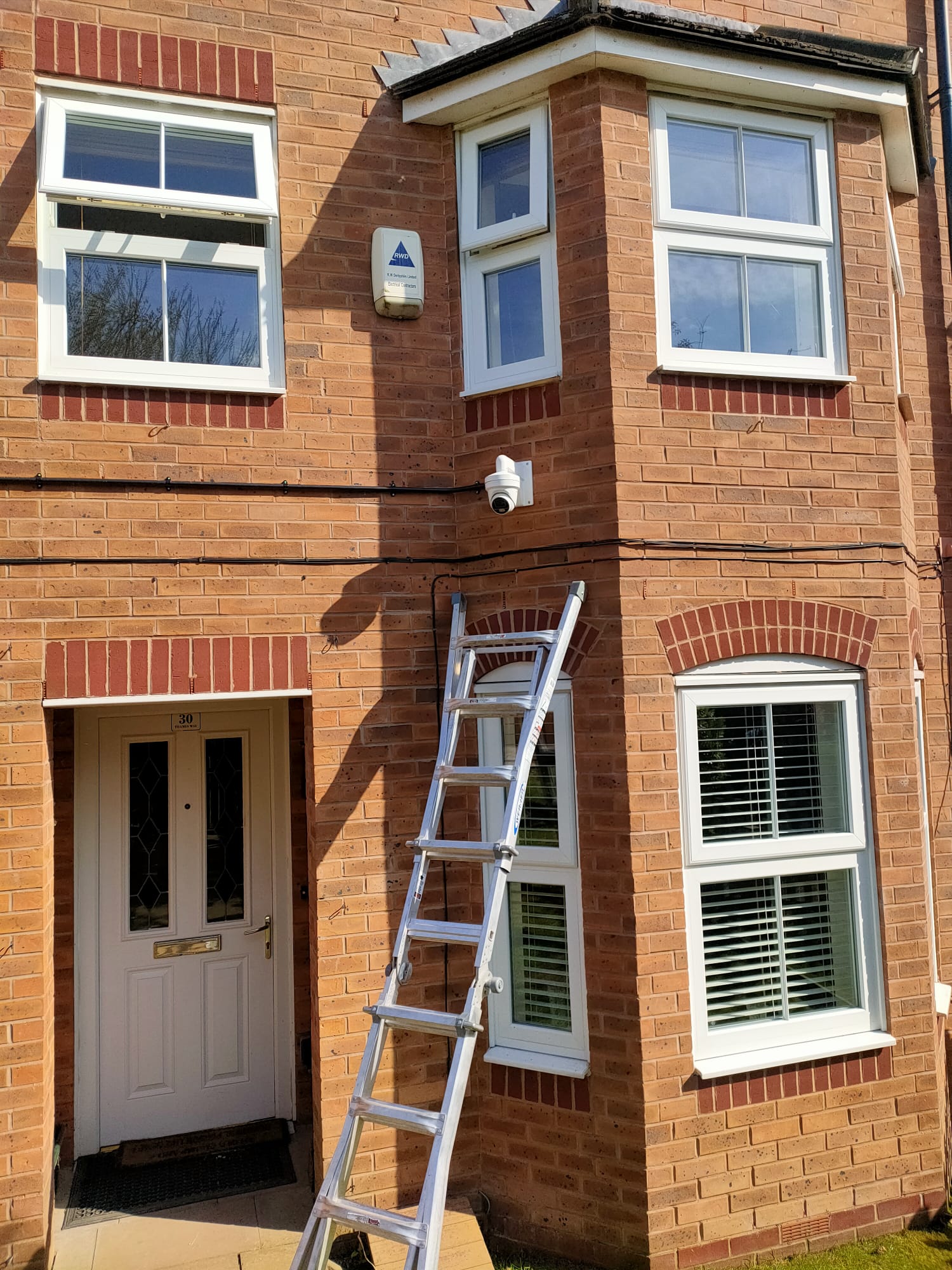 CCTV Installation, a ladder is on the side of a building and you can see the cctv camera placed