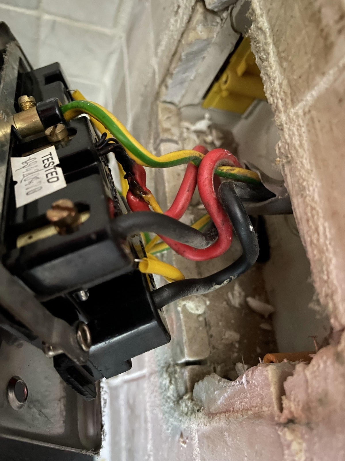 Another up close image of the fuse with the wiring bent and torn from its casing