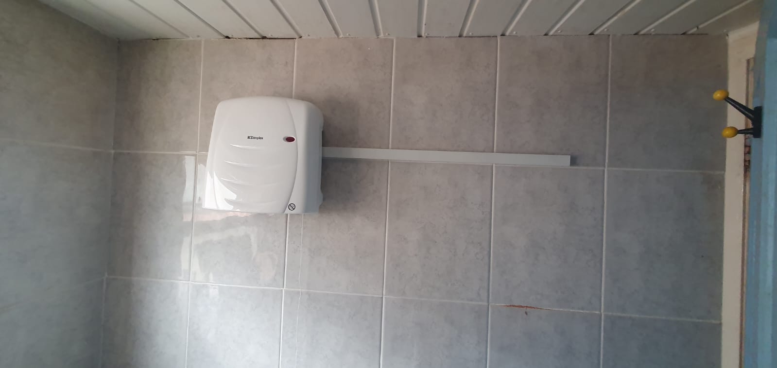 A bathroom wall along with a Fused spur to power bathroom blow heater in Normanton