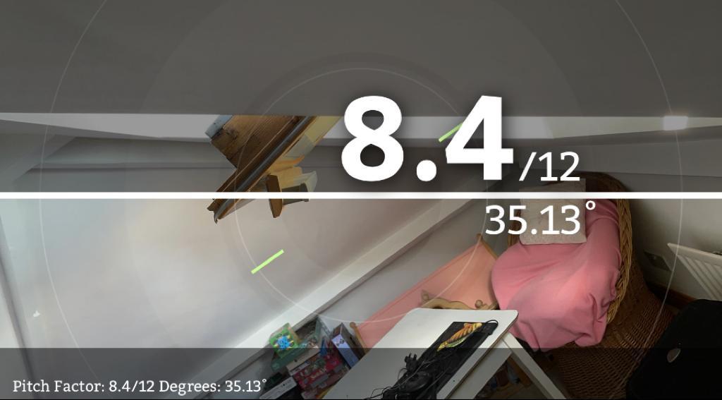 Using the “Pitch Factor” app to get the pitch of a roof during a solar panel site assessment/ It says 8.4